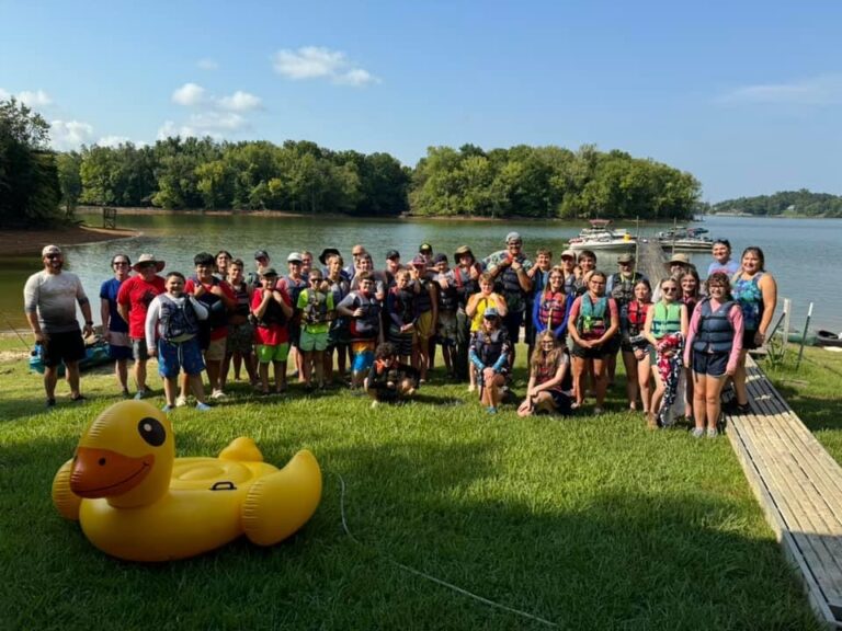 Troop 48 scouts and leaders gathered on a lakeshore
